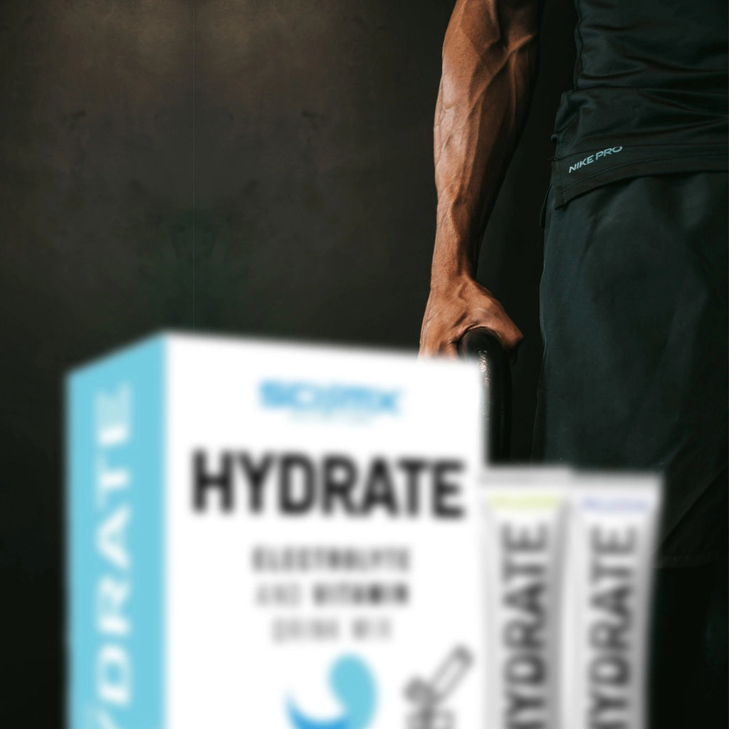 Person training with a black athletic outfit with Sci Mx HYDRATE packaging in the foreground