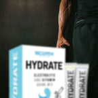 Person training with a black athletic outfit with Sci Mx HYDRATE packaging in the foreground