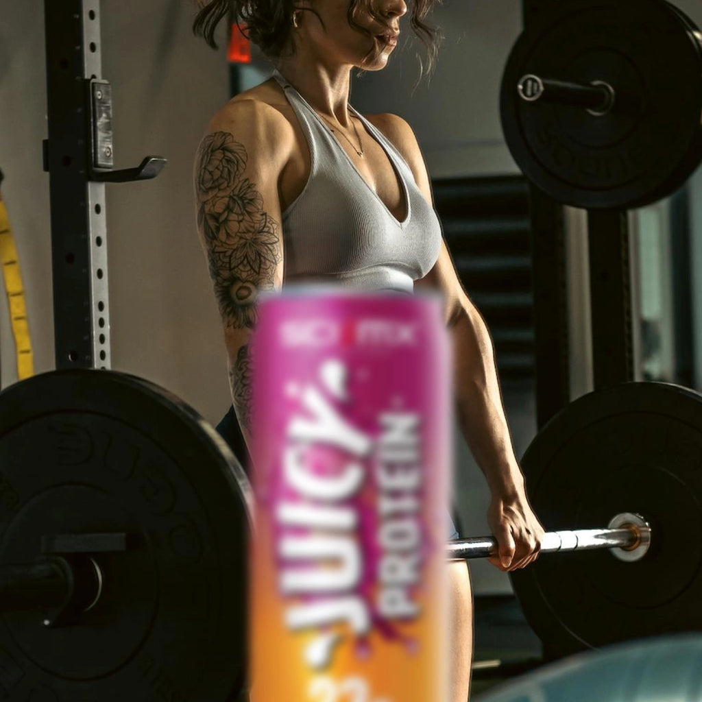 Person lifting weights with a Juicy Protein can in the foreground