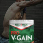 Person shadow boxing with a Sci-Mx Pro V-Gain supplement container in the foreground