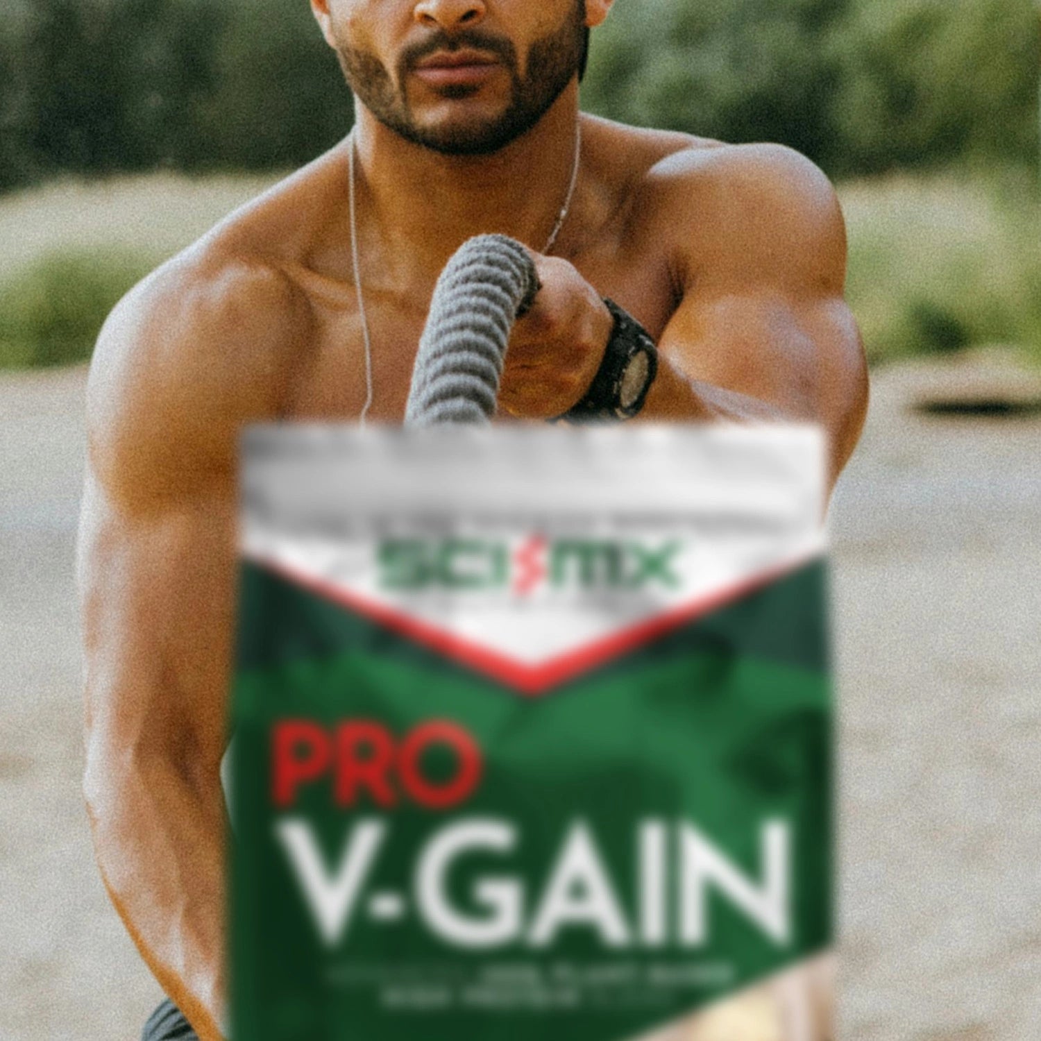 Man exercising outdoors with battle ropes and Sci-Mx Pro V-Gain supplement container in the foreground.