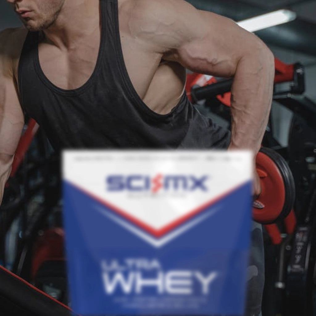 Man lifting weights with a SCI-MX Ultra Whey protein powder container in the foreground.
