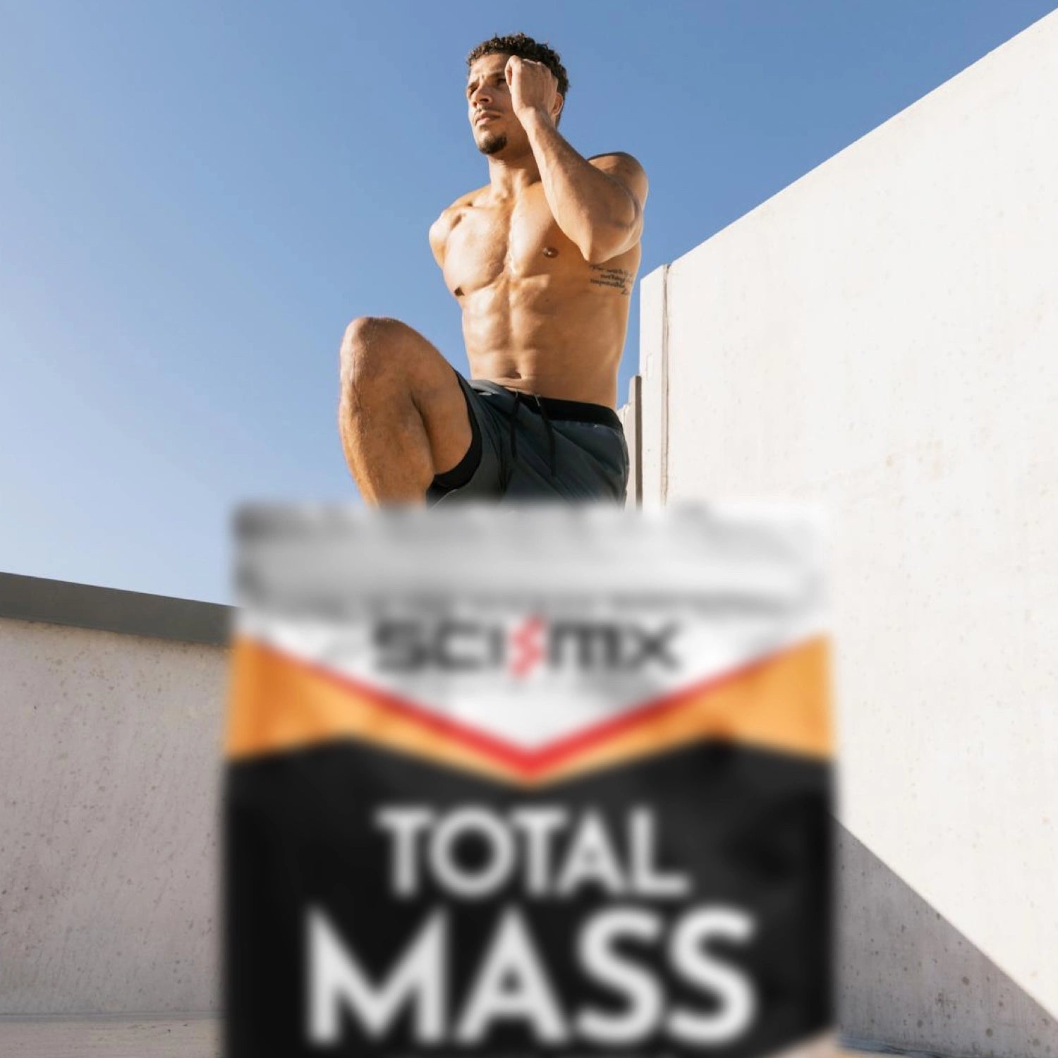 Man doing a HIT circuit with a Sci-Mx Total Mass supplement container in the foreground.