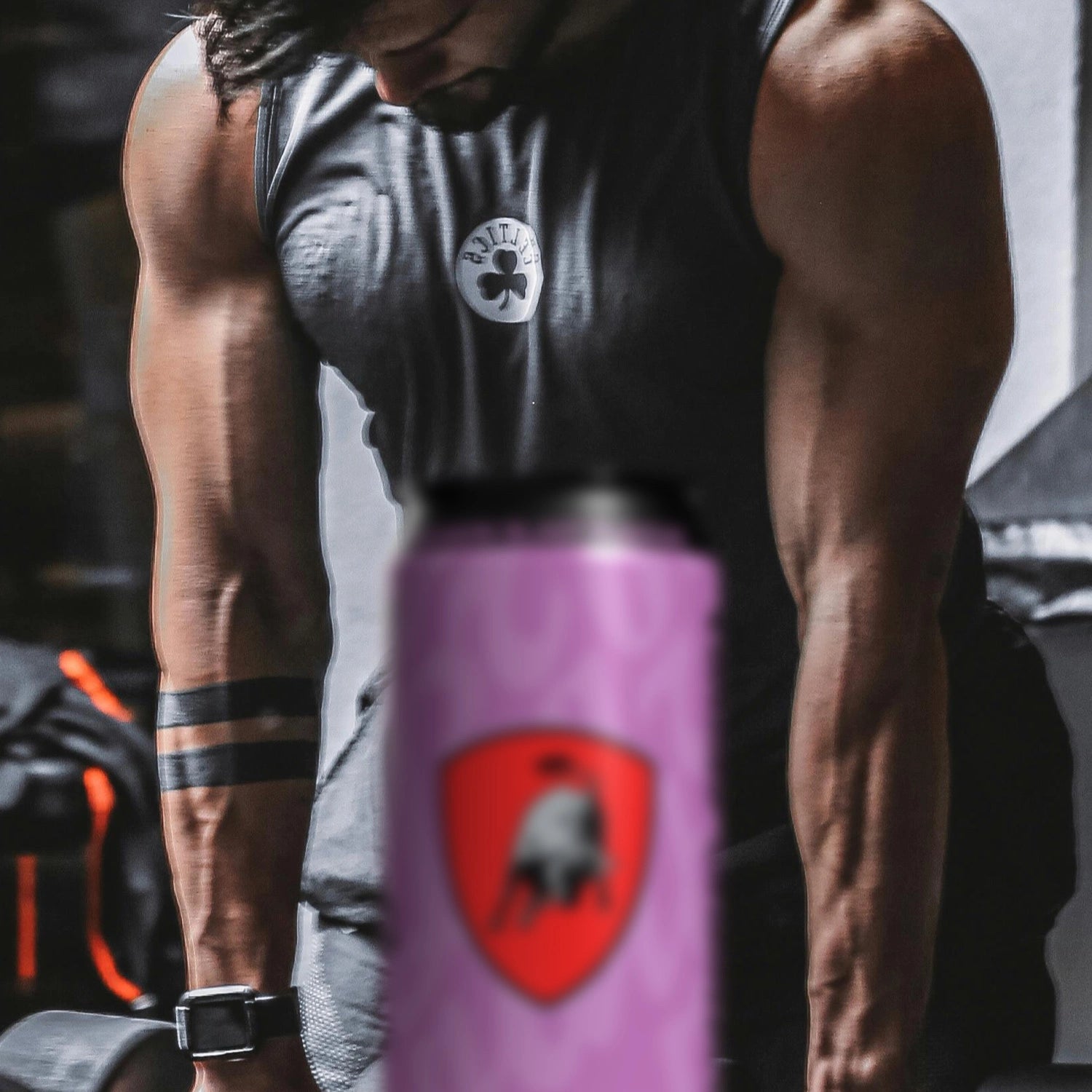 Man lifting weights with Lamborghini energy drink in the foreground