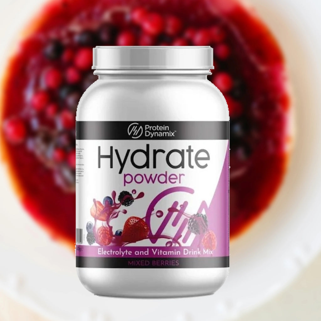 Protein Dynamix Hydrate powder container with mixed berries in the background