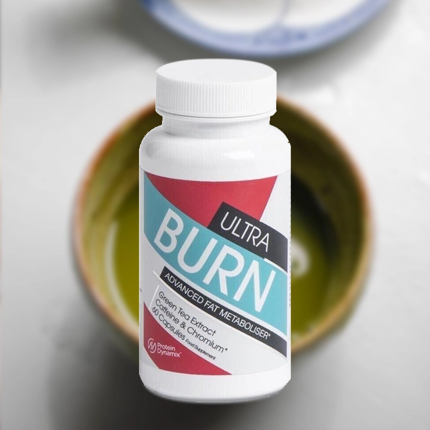 Bottle of Ultra Burn supplement with Green Tea Extract, Caffeine & Chromium with a blurred background of Green Tea