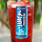 Sci-MX Juicy Protein can with a red raspberry drink in the background
