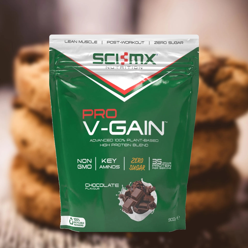 Sci-Mx Pro V-Gain protein powder chocolate flavour package with choc chip cookies in the background