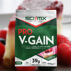 Sci-Mx Nutrition Pro V-Gain protein package with raspberries and cheesecake in the background