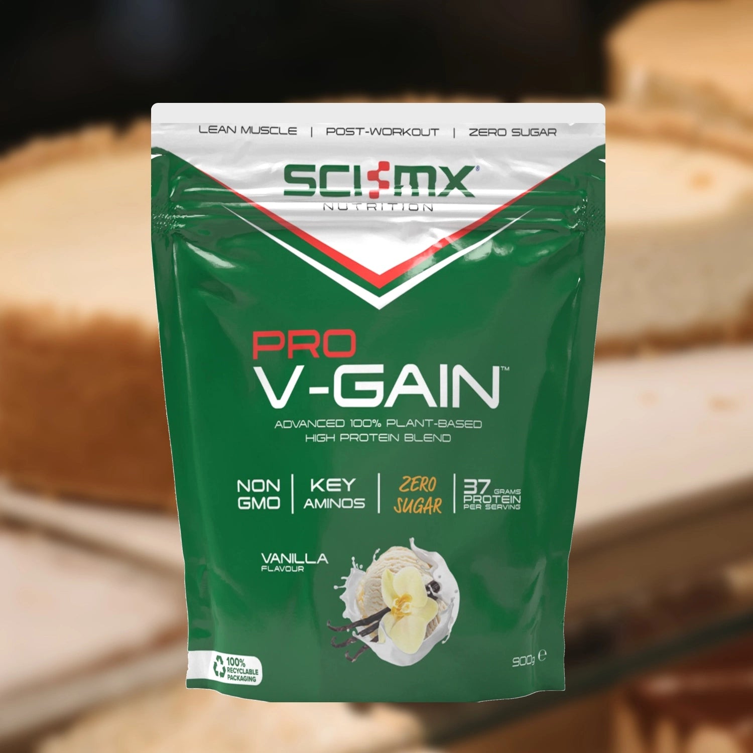 Sci-Mx Pro V-Gain protein powder package with vanilla flavour on a blurred vanilla background