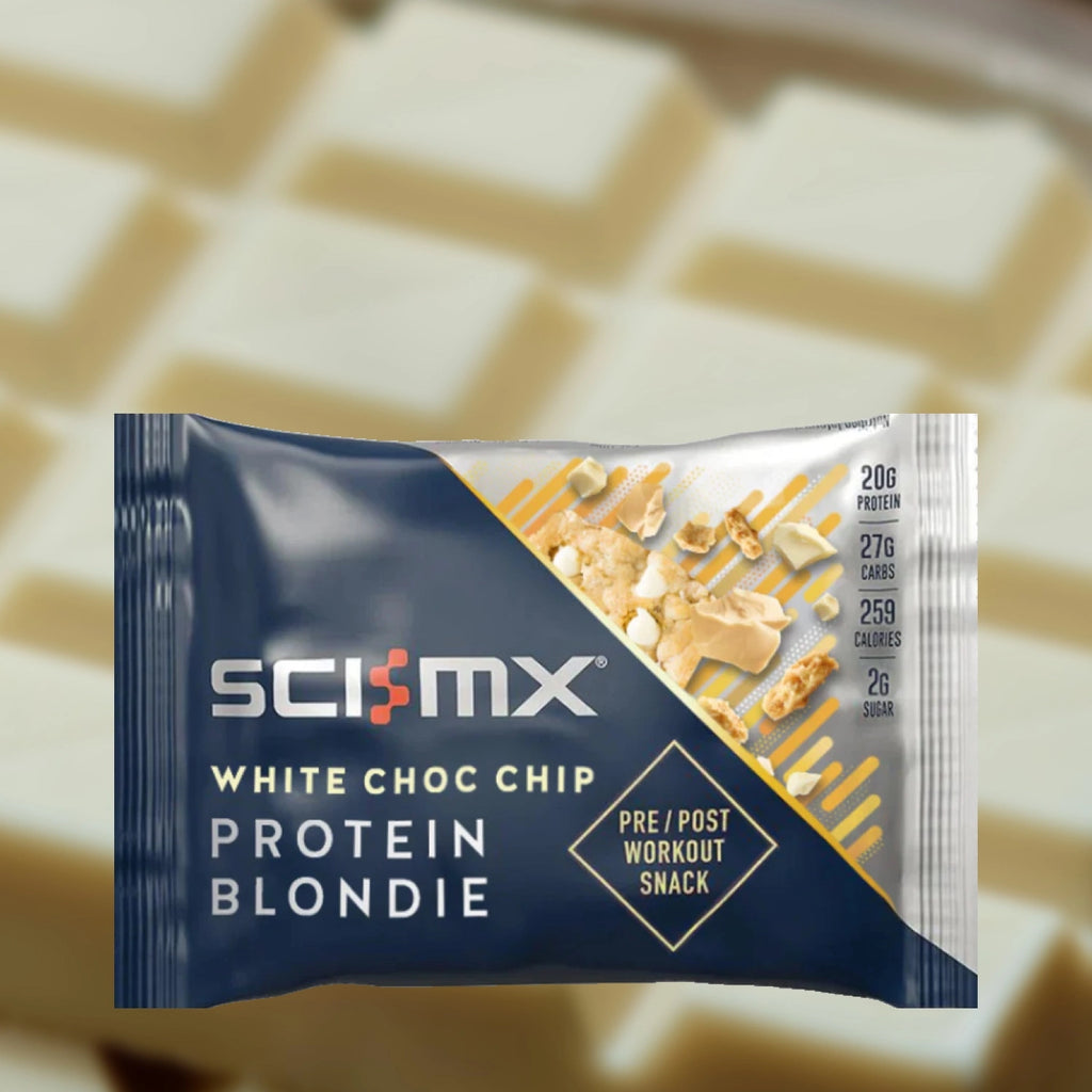 Sci-Mx White Choc Chip Protein Blondie snack package on a blurred background