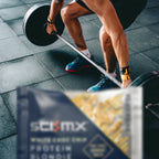 Person lifting weights with a Sci-mx protein blondie in the foreground