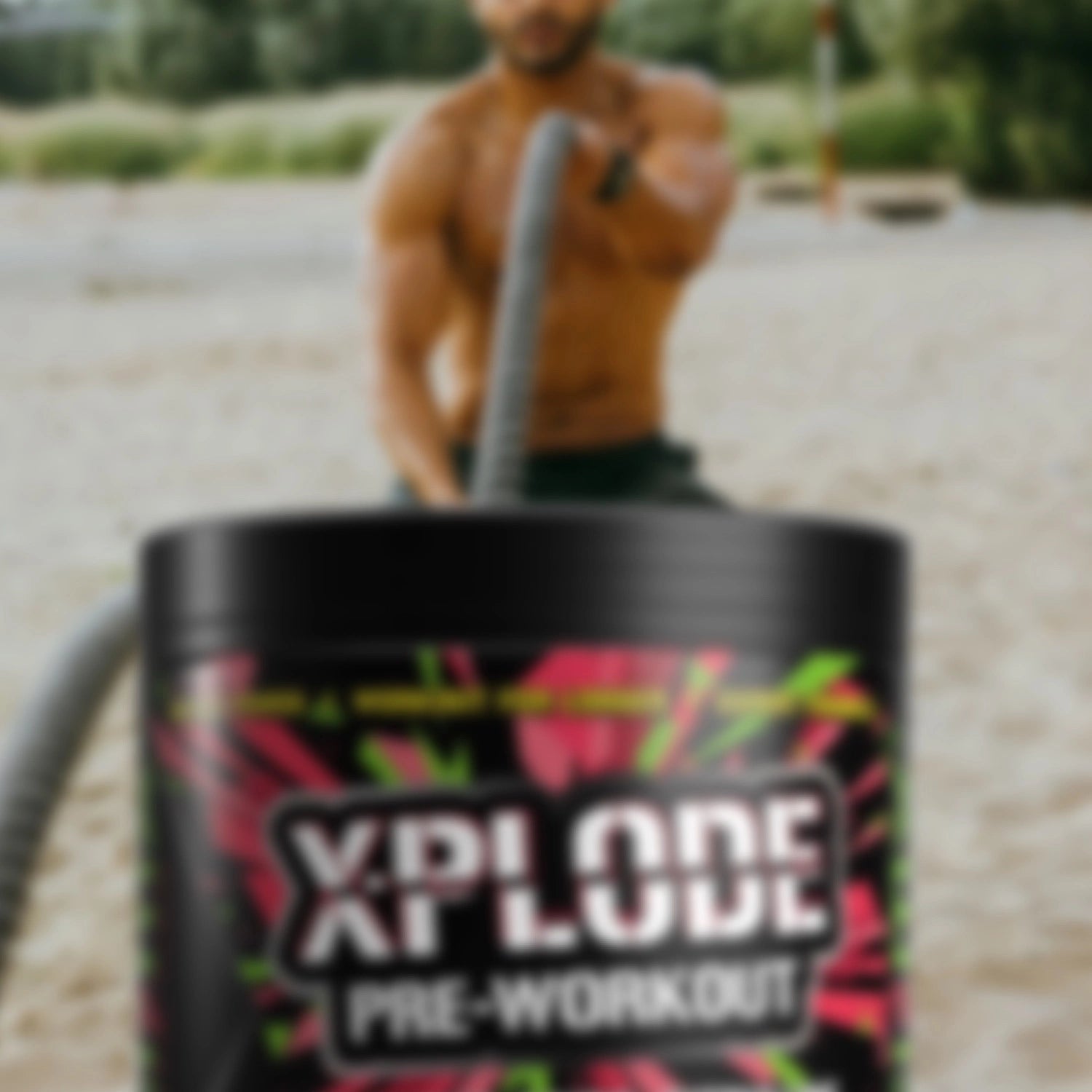 Man training on a beach with XPLODE Pre-Workout Sour Watermelon in foreground