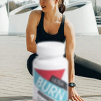 A woman in workout attire is stretching outdoors with a supplement bottle labelled 'ULTRA BURN' in the foreground.